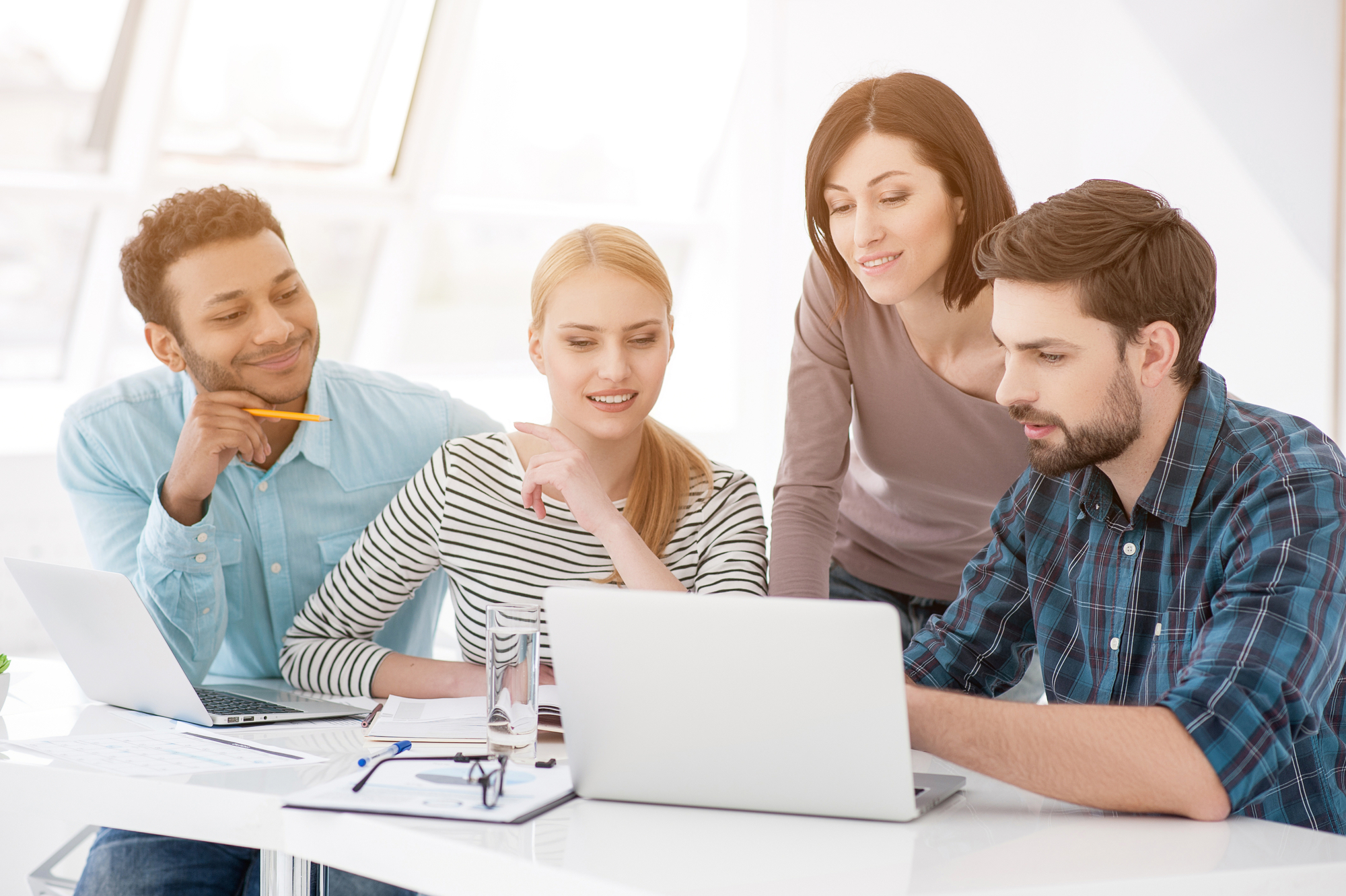 Group of young colleagues having meeting at office